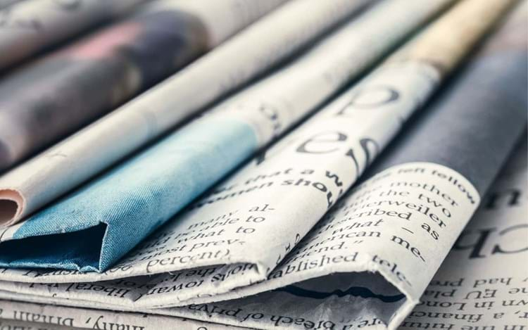 stack of folded newspapers