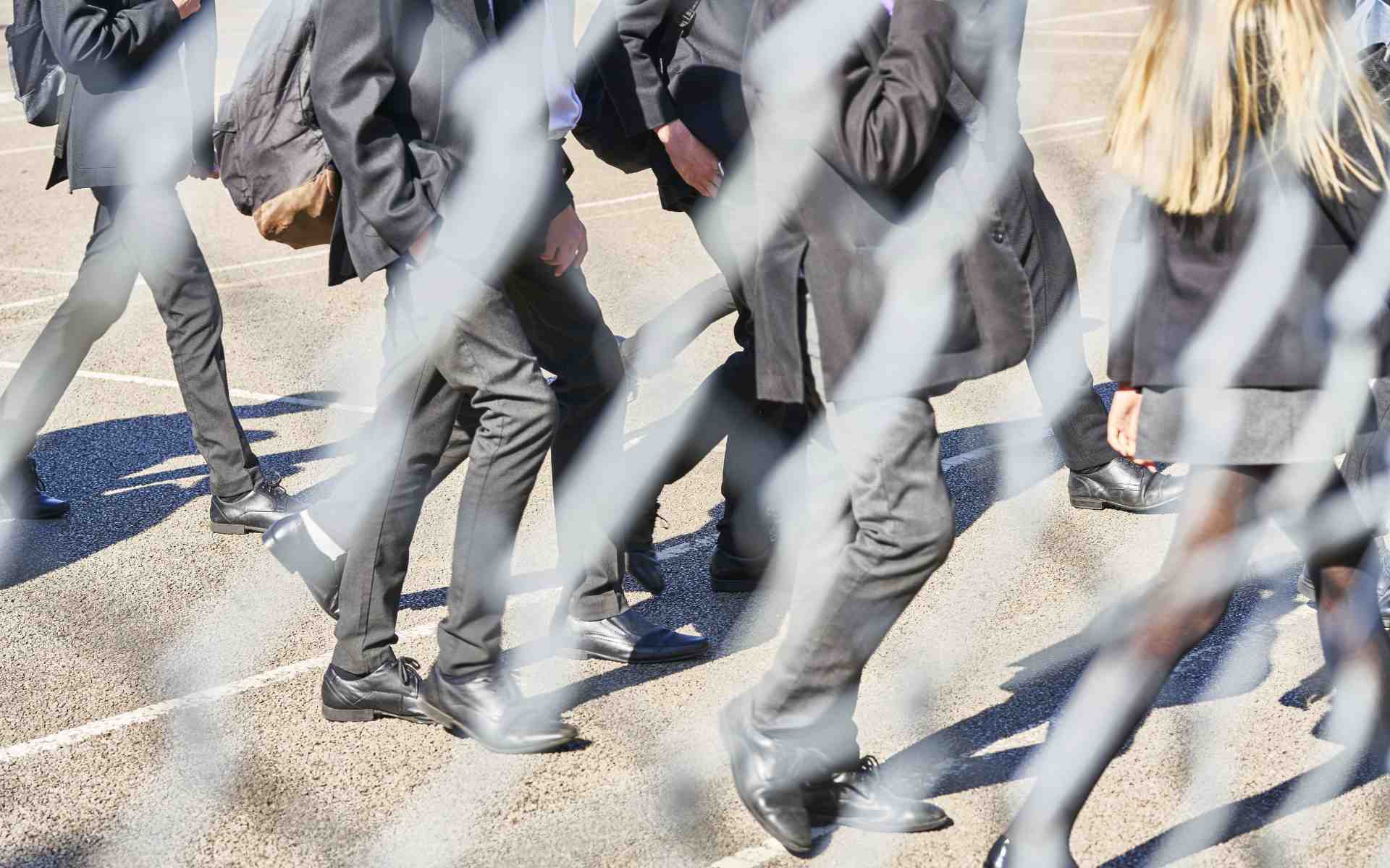 Secondary school students walking in a playground