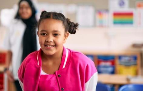 young girl wearing pink smiling
