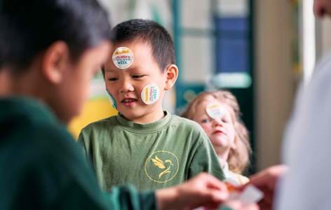 young boy with Children's Mental Health Week stickers on his face